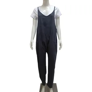 Detailed view of women's plus-size solid color suspender jumpsuit with patch pockets