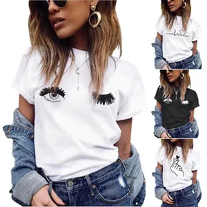Detailed view of white women's casual T-shirt featuring a stylish eyelash graphic print