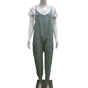 Front view of a loose sage green plus size jumpsuit on a mannequin with white t-shirt