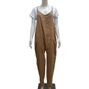 Front view of brown oversized jumpsuit with thin straps and large pockets on mannequin
