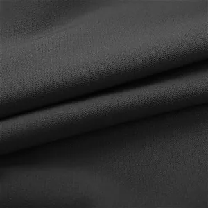 Macro shot of dark charcoal direct tribute wool fabric showing fine weave texture