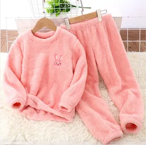 Close-up of a soft pink flannel children's pajama set featuring a cute rabbit embroidery detail