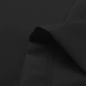 Close-up of black suit jacket fabric showing high-quality stitching and texture