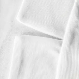 Macro detail of a white blazer showing the high quality fabric texture and lapel seam structure.
