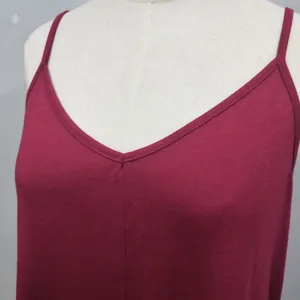 Close-up detail showing the V-neckline and fabric texture of a burgundy camisole dress