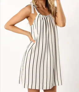 Detail of white striped dress with bow shoulder straps and gathered neckline