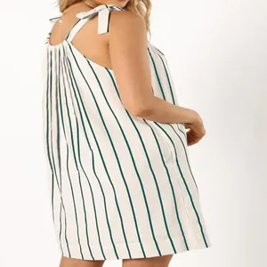 Detailed side view of a white and green vertical striped summer dress with bow shoulder straps
