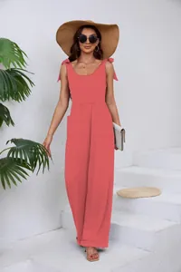 Détail d'une combinaison pantalon corail à jambes larges avec col en U et bretelles nouées.