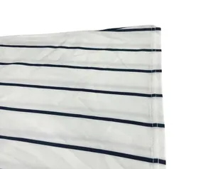 Macro view of navy blue striped fabric detail showing fine stitching on hem