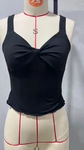 Detail view of the twist-knot front design on a black cropped tank top for women