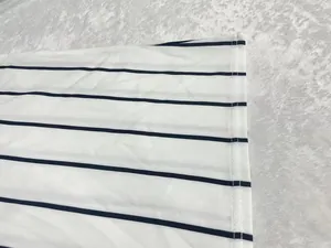 Close-up detail of white and black striped fabric showing hem stitching and texture