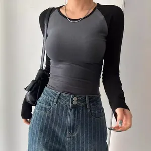 Close-up front view of a slim fit long sleeve raglan T-shirt in grey and black colors