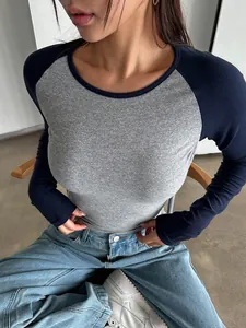Close-up of slim fit raglan long sleeve T-shirt with grey and navy contrast