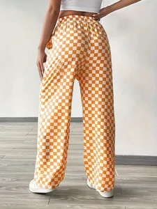 Back view of high-waist orange checkered wide-leg trousers for casual styling