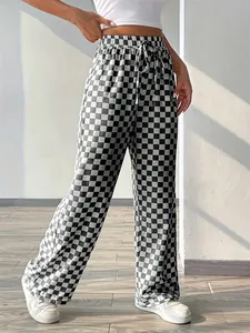 Full length view of black and white checkered high waist straight leg casual trousers