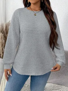 Detailed view of grey waffle texture sweatshirt for women with curved hem and long sleeves