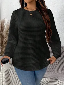 Close-up detail of plus size black quilted sweatshirt featuring a unique textured grid pattern