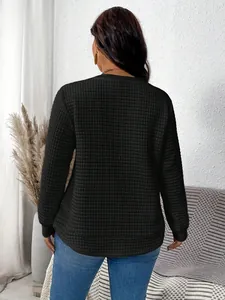 Back view of a plus-size black quilted sweatshirt with curved hem and grid texture.