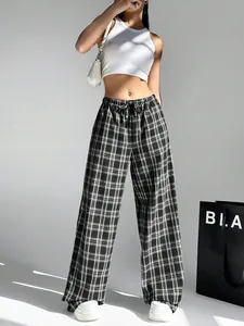 Stylish women's black and white plaid wide-leg trousers featuring a comfortable drawstring waist