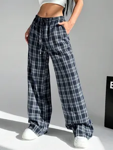 Detailed view of women's casual plaid wide-leg trousers with drawstring waist and pockets