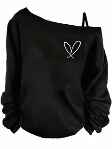 Close-up view of a black off-shoulder sweatshirt featuring a minimalist heart print detail.