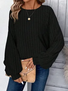 Detailed close-up of a women's black ribbed knit long sleeve sweater with a round neck.