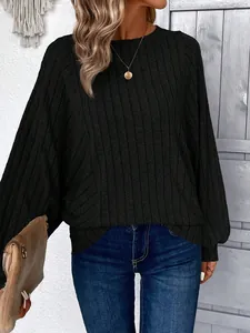 Close-up detail of a stylish black ribbed knit oversized long-sleeve sweater for women