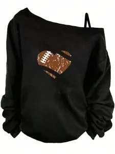 Close-up detail of black off-the-shoulder sweatshirt with distressed football heart print