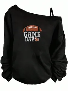 Detail view of black off-shoulder sweatshirt with Game Day football graphic print.