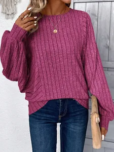 Detail view of a women's casual magenta ribbed knit long sleeve sweater with a crew neck.