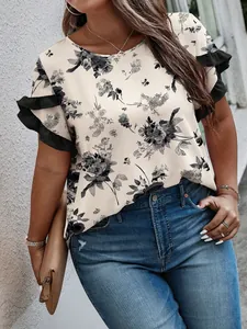 Detailed view of the elegant floral print and ruffled sleeve design on this plus size top