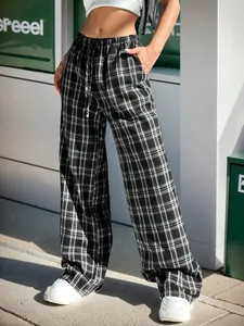 Detail of black and white plaid wide-leg pants with drawstring waist and pockets