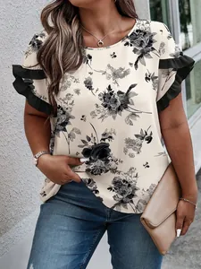 Detailed view of women's plus size cream top with black floral print and ruffled sleeves.