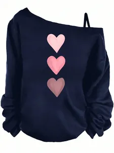 Detail of the off-shoulder neckline and heart prints on this navy long sleeve top