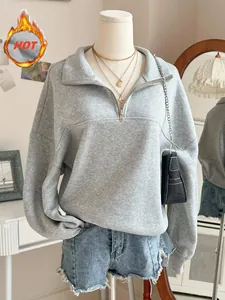 Close-up of gray oversized half-zip fleece sweatshirt with turnover collar detail.