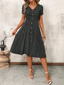 Front view of a black polka dot V-neck midi dress with decorative buttons.