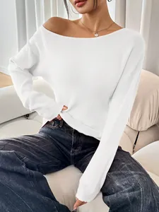 Detailed view of a white ribbed long-sleeved knit top with a wide round neckline