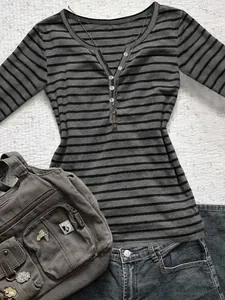 Detailed close-up view of women's grey and black striped Henley neck long-sleeve T-shirt