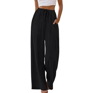 Detail of black wide-leg trousers with drawstring waist and functional pockets.