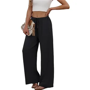 Detailed view of high-waisted black wide-leg trousers with elastic drawstring and pockets