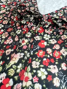 Detail view of the intricate small floral print fabric with a drawstring tie knot.