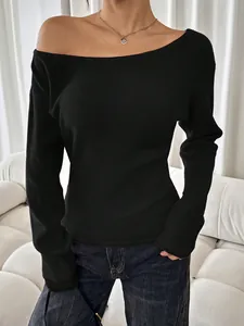 Close-up of black sexy off-the-shoulder long sleeve knit sweater with ribbed texture