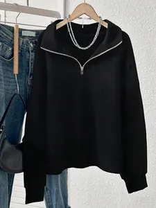 Detail view of a black half-zip sweatshirt with a lapel collar in Y2K style.