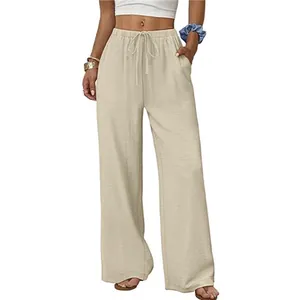 Detail of beige casual wide-leg pants featuring an elastic drawstring waist and pockets