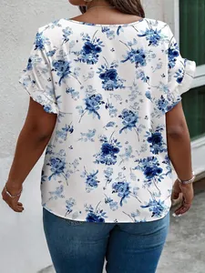 Detailed back view of a white plus size blouse featuring elegant blue floral print patterns