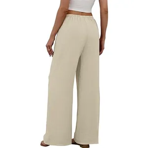 Rear view of women's beige elastic waist wide leg trousers with textured fabric