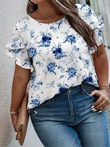 Detail view of a white floral print top with layered ruffle sleeves and a round neck.