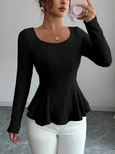 Slim fit black ribbed knit long sleeve top with elegant peplum flared hem detail.