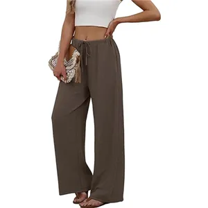 Detail of women's casual wide-leg trousers with drawstring elastic waist and pockets.