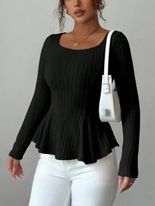 Fashionable black ribbed knit long sleeve top featuring a chic peplum hem design